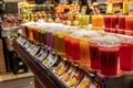 Selection of delicious fresh fruit juices in plastic containers in a Spanish market Royalty Free Stock Photo