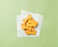 Selection of dog biscuits displayed on a white napkin on a green background Royalty Free Stock Photo