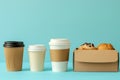 A selection of donuts, a cup of coffee, and a box of cookies arranged on blue background Royalty Free Stock Photo