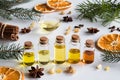 Selection of essential oils with Christmas spices on a white background