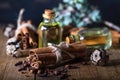 Selection of essential oils with  clove and cinnamon sticks on the wooden background Royalty Free Stock Photo