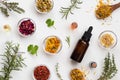 Selection of essential oils and herbs on a white background, top Royalty Free Stock Photo