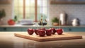 A selection of fresh fruit: cherry, sitting on a chopping board against blurred kitchen background copy space