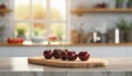 A selection of fresh fruit: cherry, sitting on a chopping board against blurred kitchen background copy space