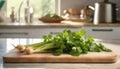 A selection of fresh herbs: coriander leaves, sitting on a chopping board against blurred kitchen background copy space