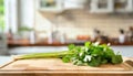 A selection of fresh herbs: coriander leaves, sitting on a chopping board against blurred kitchen background copy space