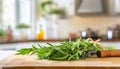 A selection of fresh herbs: tarragon, sitting on a chopping board against blurred kitchen background copy space