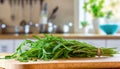 A selection of fresh herbs: tarragon, sitting on a chopping board against blurred kitchen background copy space