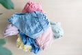 Selection of fresh unfolded laundry in white basket on wood table