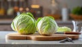 A selection of fresh vegetable: cabbage, sitting on a chopping board against blurred kitchen background copy space Royalty Free Stock Photo