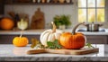 A selection of fresh vegetable: pumpkin, sitting on a chopping board against blurred kitchen background copy space