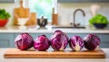 A selection of fresh vegetable: red cabbage, sitting on a chopping board against blurred kitchen background copy space Royalty Free Stock Photo