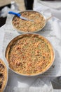 Selection of freshly-baked pies arranged on white paper with knives, ready to be enjoyed Royalty Free Stock Photo