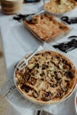 Selection of freshly-baked pies arranged on white paper with knives, ready to be enjoyed