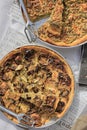 Selection of freshly-baked pies arranged on white paper with knives, ready to be enjoyed Royalty Free Stock Photo