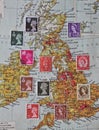 Selection of GB Postage stamps over old map