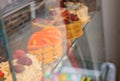 Selection of gourmet cakes in a bakery window