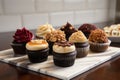 selection of gourmet cupcakes, including red velvet, salted caramel, and peanut butter & jelly Royalty Free Stock Photo