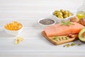 Selection of healthy unsaturated fats, omega 3 - fish, avocado, olives, nuts and seeds. Royalty Free Stock Photo