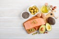 Selection of healthy unsaturated fats, omega 3 - fish, avocado, olives, nuts and seeds. Royalty Free Stock Photo