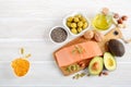 Selection of healthy unsaturated fats, omega 3 - fish, avocado, olives, nuts and seeds. Royalty Free Stock Photo