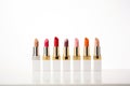 selection of highend lipsticks in a row against white