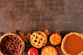 Selection of homemade autumn pies. Bottom border on a dark stone background.