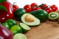 A selection of juicy fruits and vegetables on a wooden and white background. Royalty Free Stock Photo