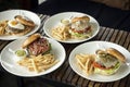 Selection of many different burgers on restaurant table Royalty Free Stock Photo