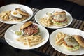 Selection of many different burgers on restaurant table Royalty Free Stock Photo