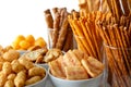 Selection of many types of savory snacks in white ceramic dishes
