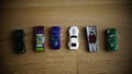 Selection of Mattel Hot Wheels toy model cars on a wooden floor