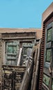 Selection of old carved doors and windows stacked in the corner of an adobe walled outside area Royalty Free Stock Photo