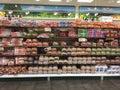 Packaged bread section in supermarket. Long aisle loaves of bread for sale in grocery store