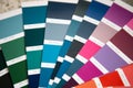 Selection of the paint color for decorative home repairs to the palette with layouts. A fan of shades in your hand inside the home