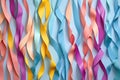 a selection of paper streamers in rainbow colors laid out on a pastel surface Royalty Free Stock Photo