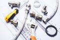A selection of plumbing tools and fittings on domestic house plans Royalty Free Stock Photo