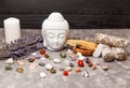 Selection of semiprecious stones. Ceramic statuette of a Buddha head.