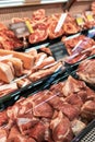 Selection of quality meat at a butcher shop, beef and pork, ham, vertical photo Royalty Free Stock Photo