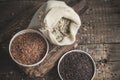 Selection of red, black and mixed rice on an old wooden background.Top view with copy space Royalty Free Stock Photo