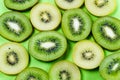 Selection of slices of yellow and green kiwi fruit on a bright high contrast green background Royalty Free Stock Photo