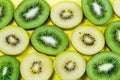 Selection of slices of yellow and green kiwi fruit on a bright high contrast yellow background Royalty Free Stock Photo