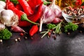 Selection of spices herbs and greens. Ingredients for cooking. Food background on black slate table Royalty Free Stock Photo