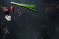 Selection of spices herbs and greens. Ingredients for cooking. Food background on black slate table. Royalty Free Stock Photo