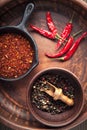 Selection of spices pepper. Food background on black wood table. Royalty Free Stock Photo