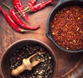 Selection of spices pepper. Food background on black wood table. Top view Royalty Free Stock Photo