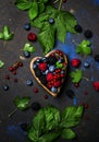 Selection of summer berries in heart shape bowl, food background Royalty Free Stock Photo