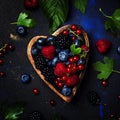 Selection of summer berries in heart shape bowl, food background Royalty Free Stock Photo