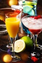 Selection of summer cocktails. Cold refreshing alcoholic beverages and drinks: mimosa, cosmopolitan, raspberry margarita and blue Royalty Free Stock Photo