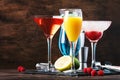 Selection of summer cocktails. Cold refreshing alcoholic beverages and drinks: mimosa, cosmopolitan, raspberry margarita and blue Royalty Free Stock Photo